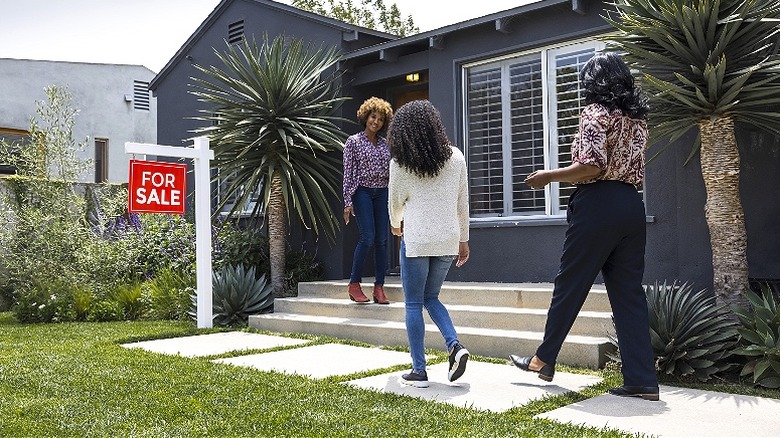 Buyers walking to house for sale