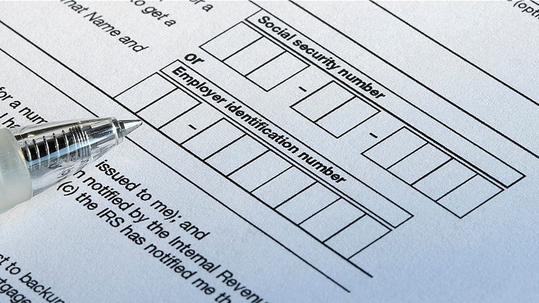 A pen on a blank form about to fill out Social Security number