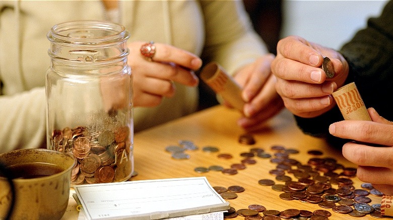 Couple rolling coins at home