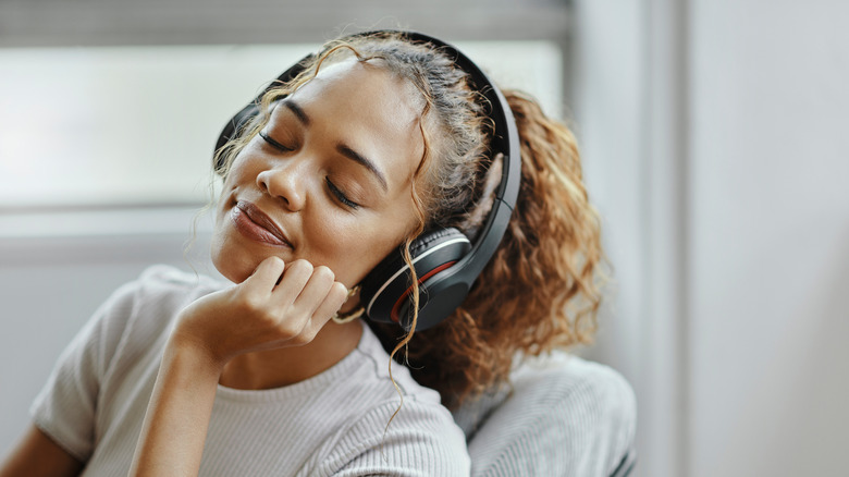 A woman relaxing and listening to music