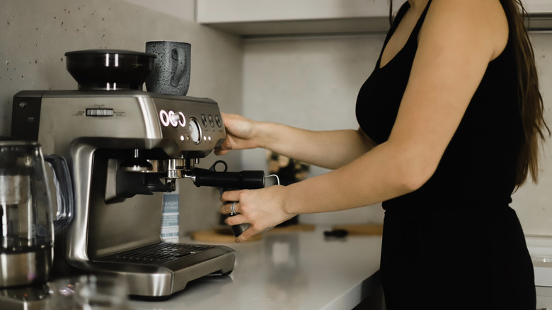 Woman making espresso at home