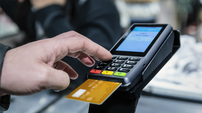 Person using a debit card to pay