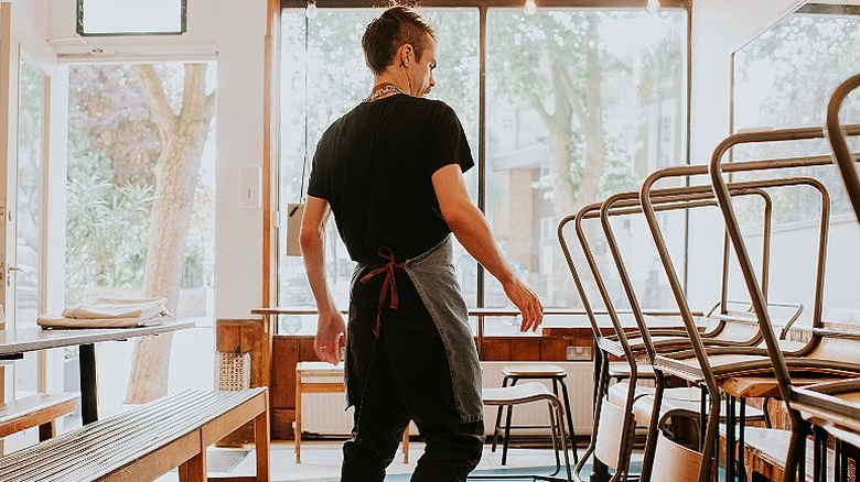 Worker walks through empty cafe