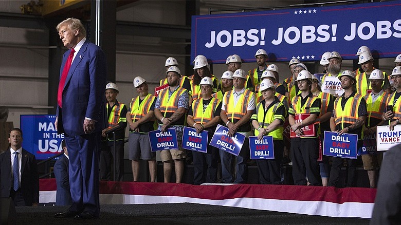 Trump standing on stage at rally