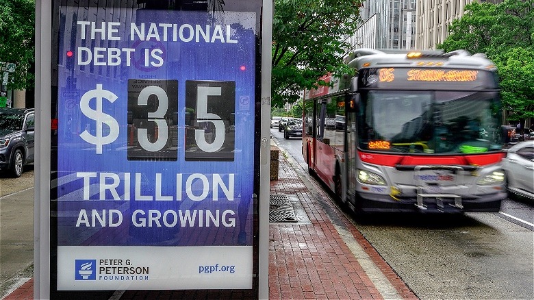 Bus stop displaying national debt