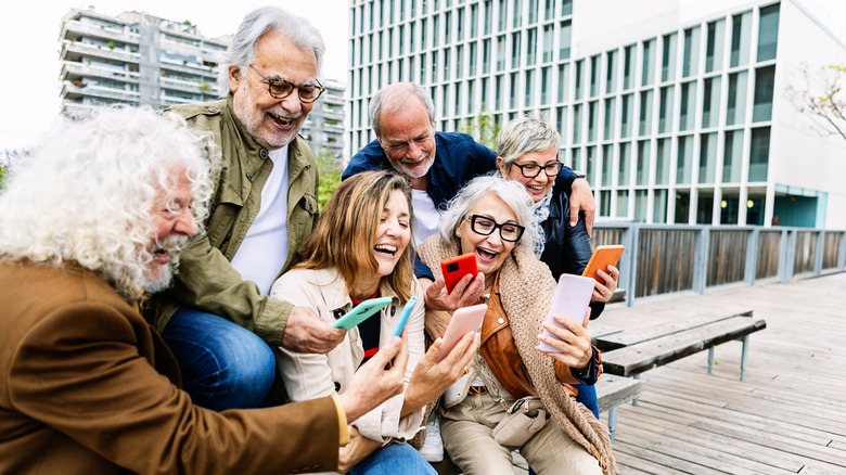 a group of baby boomers on their phones