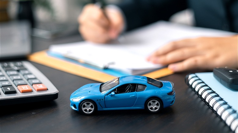 Toy car, auto loan paperwork 