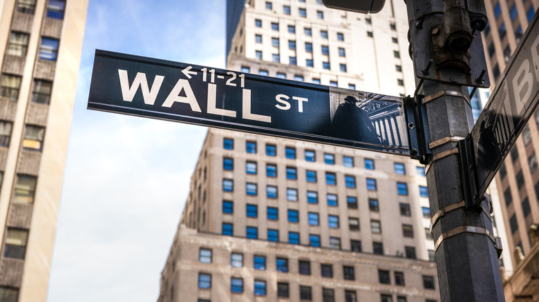 Wall Street street sign in the New York City financial district on a sunny day.