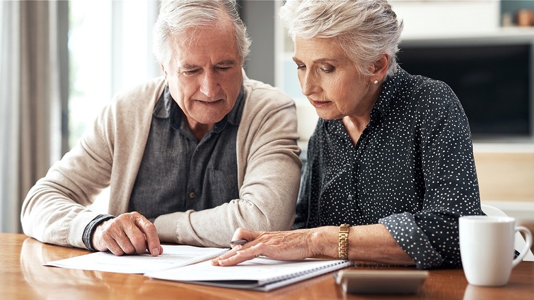 Older couple reviewing paperwork together