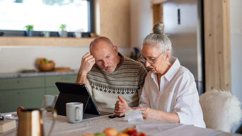 Senior couple reviewing receipts