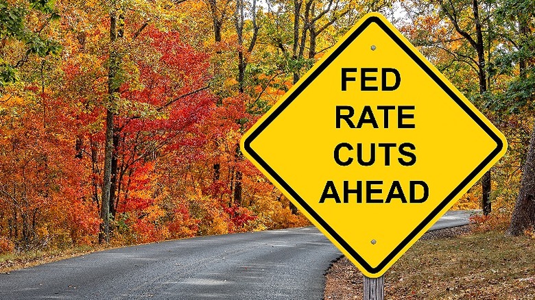 Yellow road sign indicating upcoming interest rate cuts