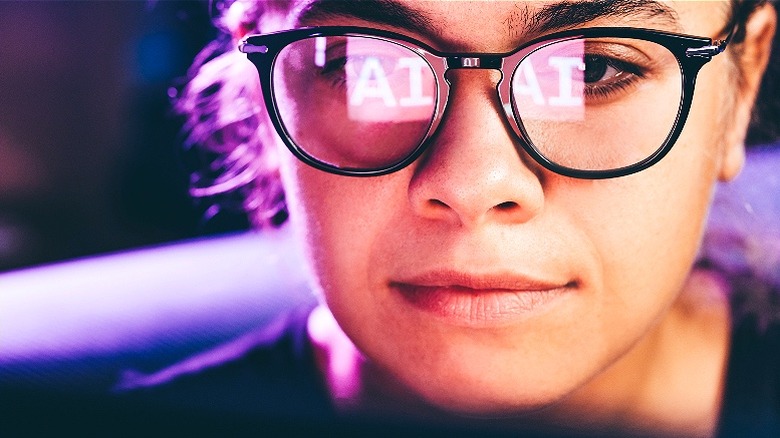 AI reflected in person's glasses