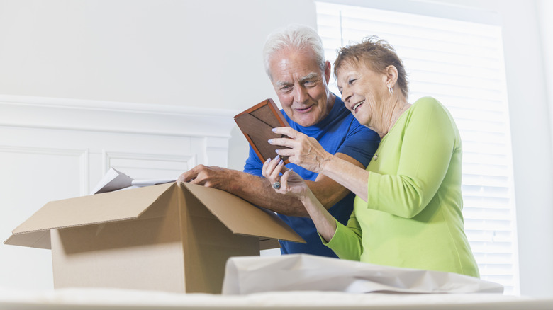 Senior couple unpacking boxes