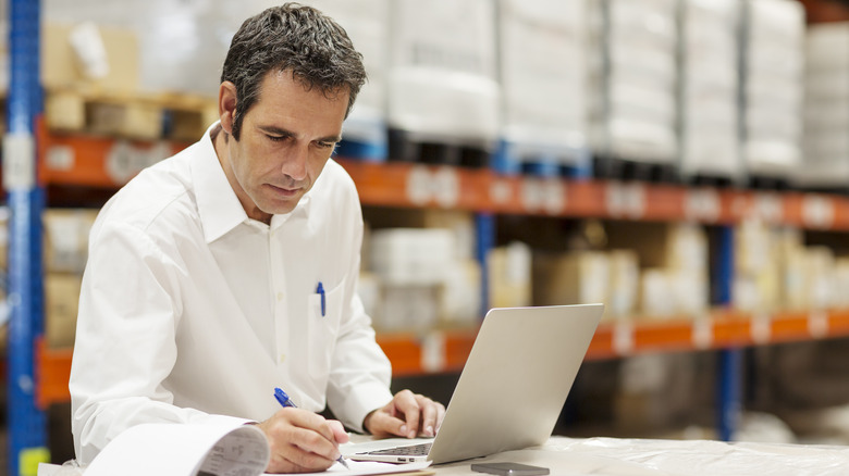 A man auditing inventory