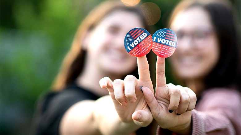 Two people with "I voted" stickers