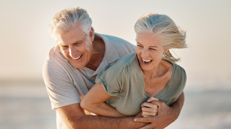 elderly couple having fun on beach