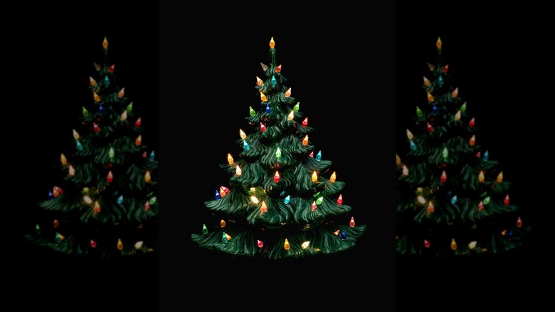 Ceramic Christmas tree lights up against black