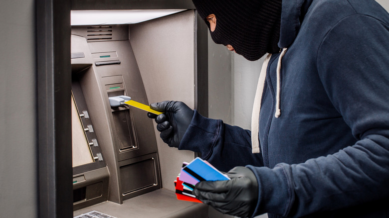 A thief stealing from an ATM