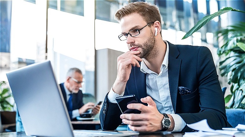 Person reading laptop in office