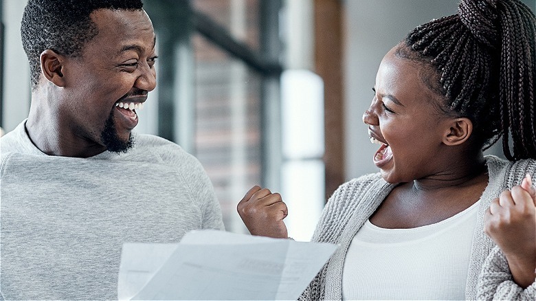 Couple reacting happily to mail