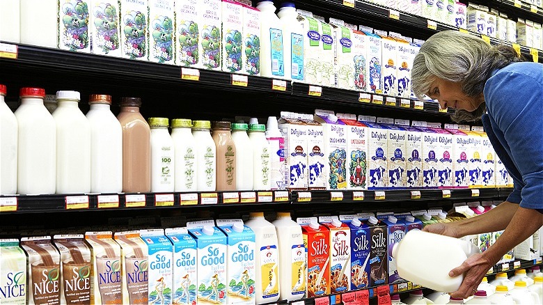 Person checking milk at store