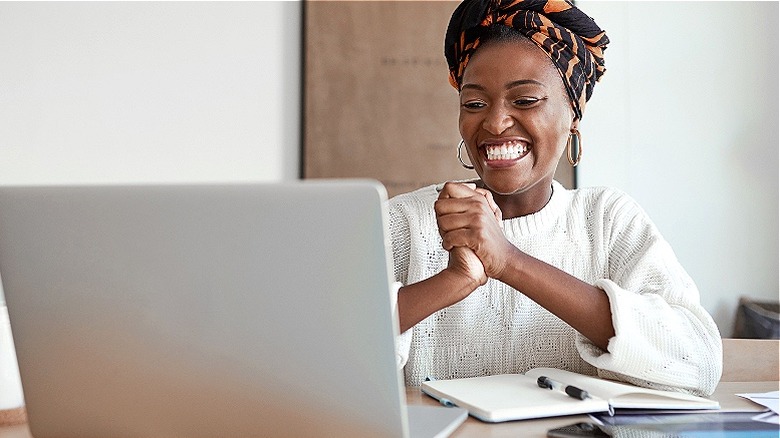 Happy woman at laptop computer