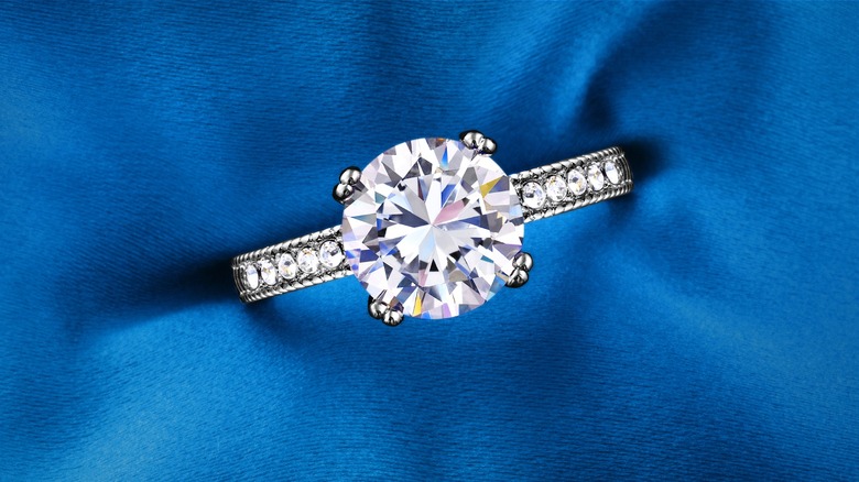 Engagement ring on blue pillow