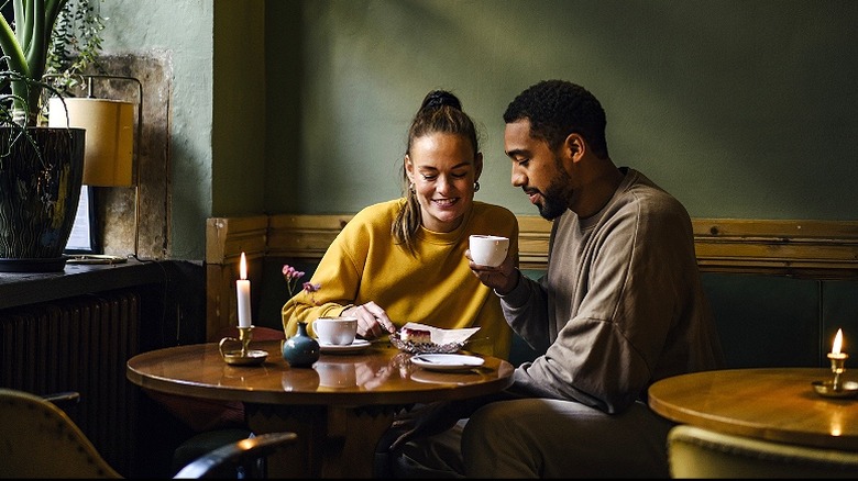 Couple chats in coffee shop