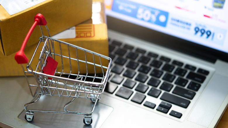 A miniature shopping cart on a laptop