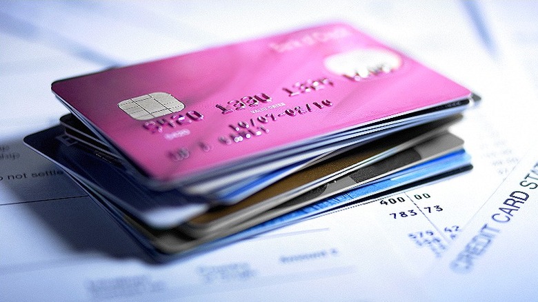 Stack of credit cards on card statement documents